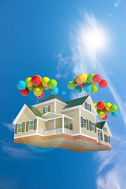 istock Home flying in the sky with balloons, with sun 528132075