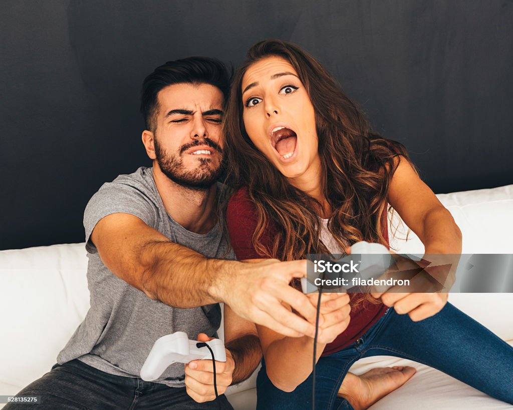 Video games Man and woman playing a video games. 20-29 Years Stock Photo