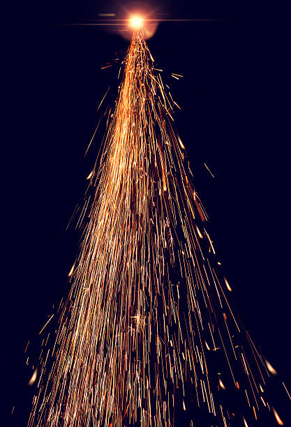 Welding sparks in the shape of a Christmas tree. stock photo