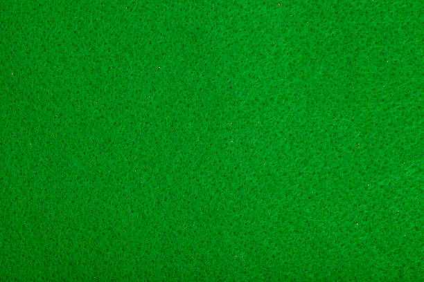 istock Close-up of green poker table felt background 528136015