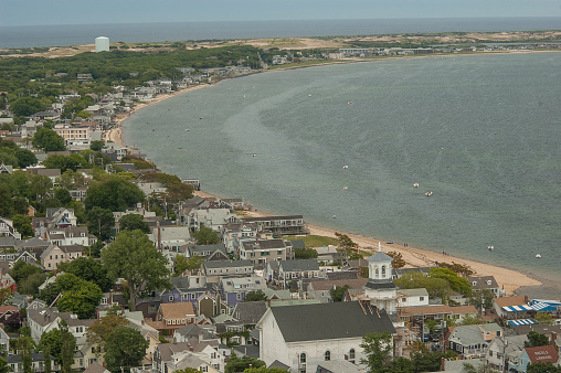 Provincetown, MA, USA-June 14, 2009: Provincetown is a fishing and tourist community located at the far end and tip of Cape Cod. This is an aerial shot of the town as it curves along the coast, with the ocean in view.