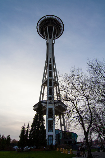 Seattle, WA, USA - December 28, 2005: View of the Space Needle in Seattle Center. A family strolls by with toddler in stroller. 