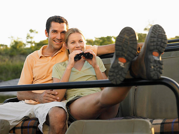 istock Couple Sitting In Jeep With Binoculars 528145963