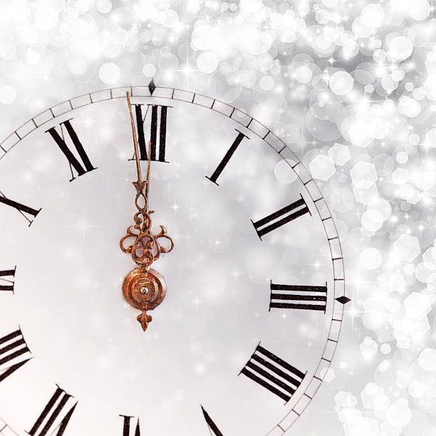 istock New Year's at midnight - Old clock and holiday lights 528146841