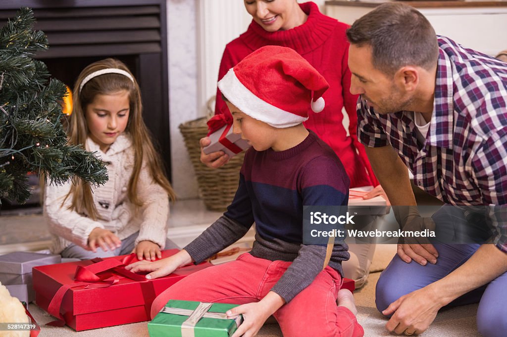 Love family opening gifts at christmas Love family opening gifts at christmas at home in the living room 10-11 Years Stock Photo