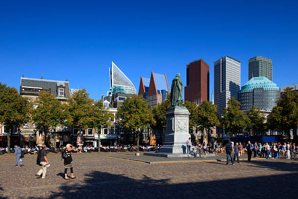 The Hague, Netherlands - September 3, 2014: pedestrians on Plein in The Hague with the modern office towers in the background