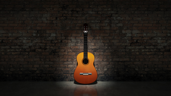 Acoustic guitar leaning on grungy wall