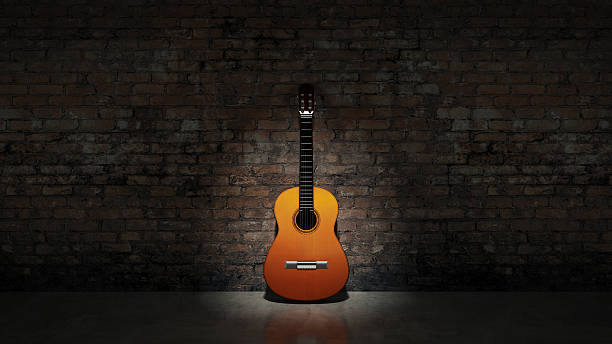 Acoustic guitar leaning on grungy wall Acoustic guitar leaning on grungy wall flamenco dancing photos stock pictures, royalty-free photos & images