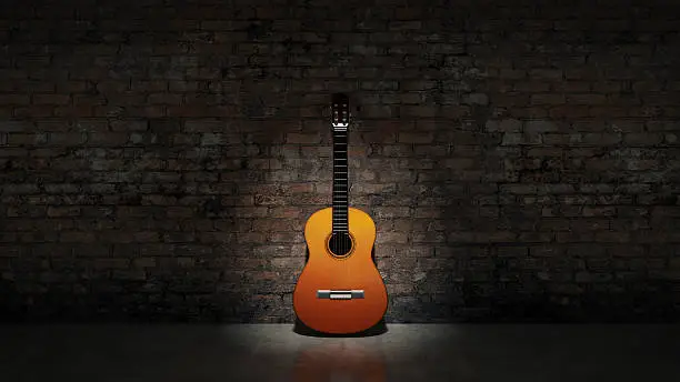 Photo of Acoustic guitar leaning on grungy wall