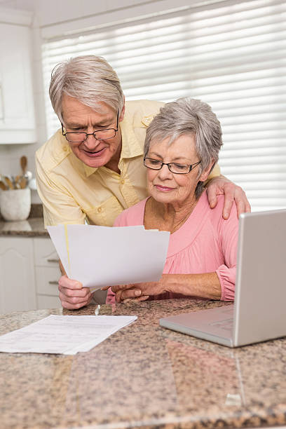 istock Senior couple paying their bills with laptop 528150631