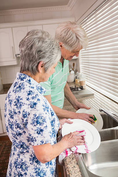 istock Senior couple washing the dishes 528151205