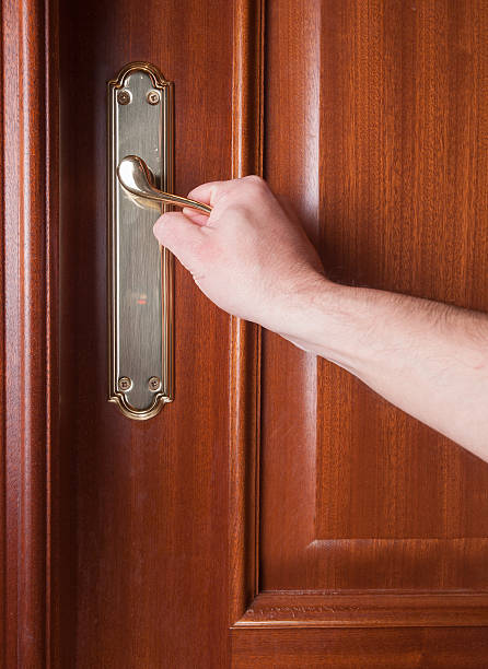istock Hand gripping the handle of a door 528151359