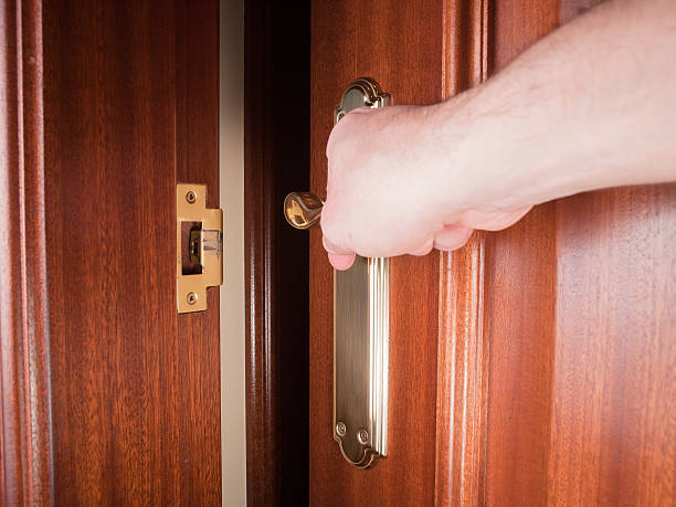 istock Hand gripping the handle of a door 528162939