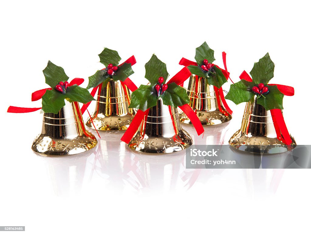Gold christmas bells Gold christmas bells with red ribbon and green leaf isolated on a white background Blank Stock Photo
