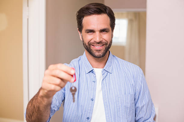 istock Casual man showing his house key 528164481
