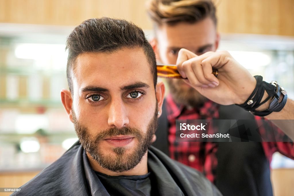 Young Man at the Barber Young Man at the BarberYoung Man at the Barber Men Stock Photo