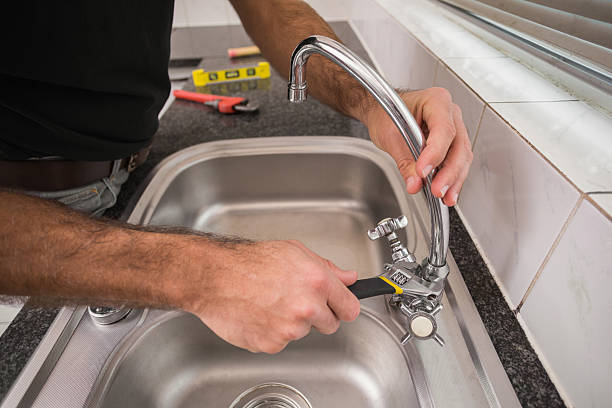 istock Plumber fixing the sink with wrench 528165549