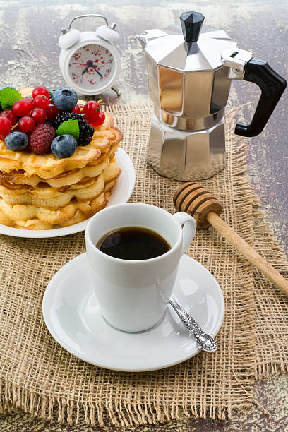 istock Freshly brewed black coffee and waffles with berries for breakfast 528165823