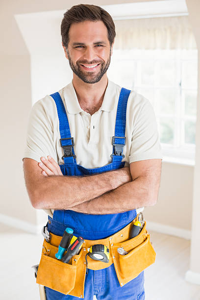 istock Handyman smiling at camera in tool belt 528165977