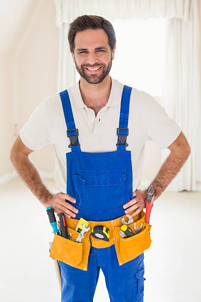 istock Handyman smiling at camera in tool belt 528166017