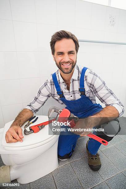 Plumber Smiling At The Camera Stock Photo - Download Image Now - Bathroom, Construction Industry, Men