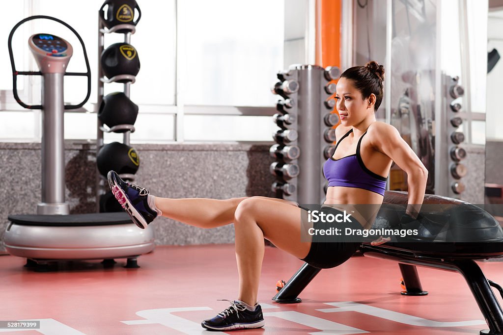 Doing press-ups Young woman doing press-ups in the gym Activity Stock Photo