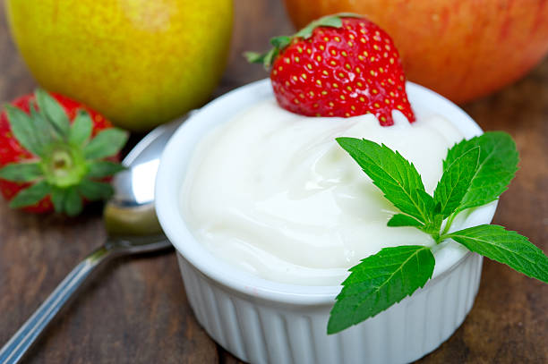 istock Fresh fruits and yoghurt on a rustic wooden table. 528179919