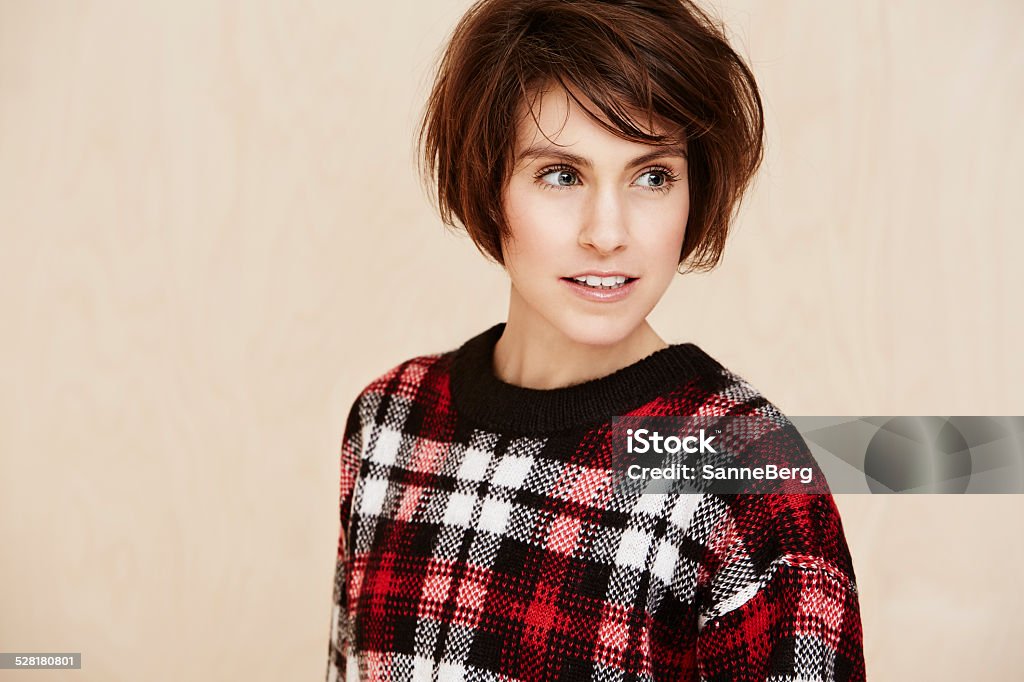 Mid adult woman in checked top, looking away 30-34 Years Stock Photo