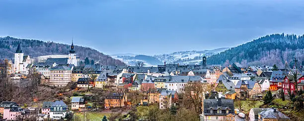 Panoramic view on the mining town of Schwarzenberg (Erzgebirge / Ore Mountains) illuminated by christmas lights on a winter day.