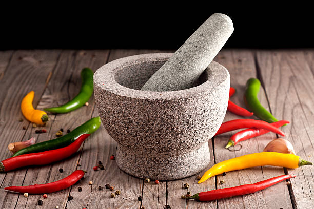 istock Stone Mortar on a wooden bench. 528184071
