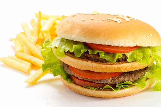 istock Big and tasty hamburger and fried potatoes isolated 528184339