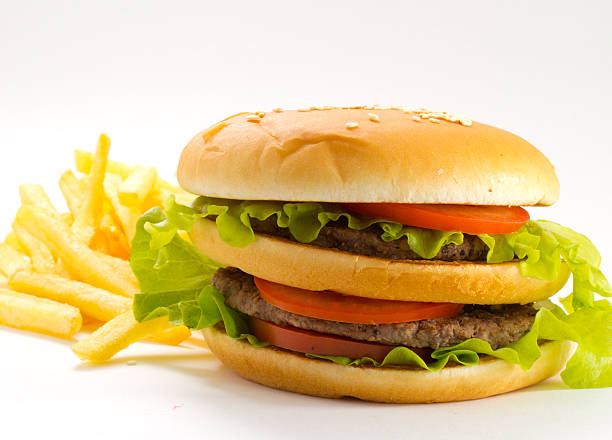 istock Big and tasty hamburger and fried potatoes isolated 528184351