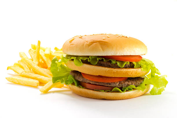 istock Big and tasty hamburger and fried potatoes isolated 528184367