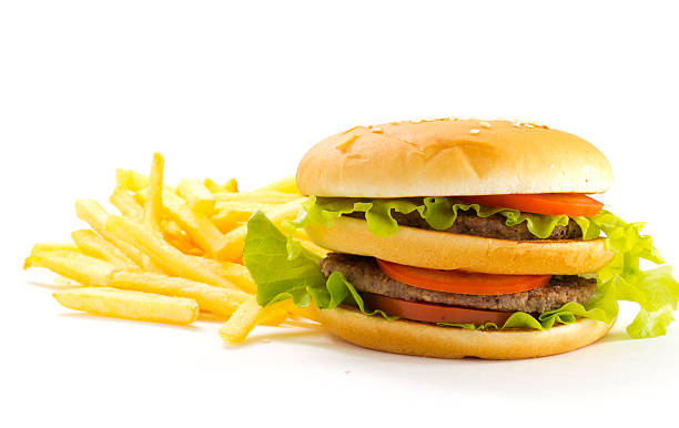 istock Big and tasty hamburger and fried potatoes isolated 528184371