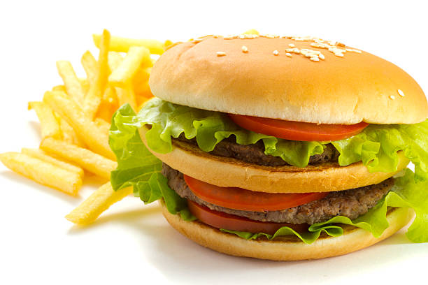istock Big and tasty hamburger and fried potatoes isolated 528184443