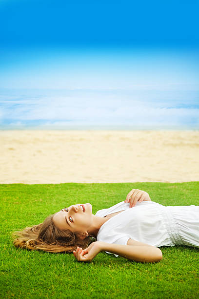 istock Woman lying on the grass 528185823