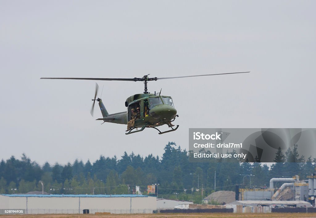 UH-1 Huey Lakewood, United States - July 17, 2010: Joint Base Lewis-McChord opens its gates to the public for a free airshow every few years.  This image shows a UH-1 Huey helicopter that was flying over the show. Air Vehicle Stock Photo