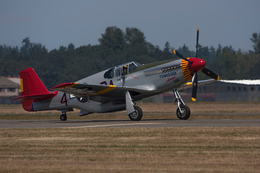 Lakewood, United States - July 17, 2010: Joint Base Lewis-McChord opens its gates to the public for a free airshow every few years.  This image shows a vintage propeller plane being flown by one of the Tuskegee Airmen.  The Tuskegee Airmen were the first African-American military aviators in the United States armed forces.