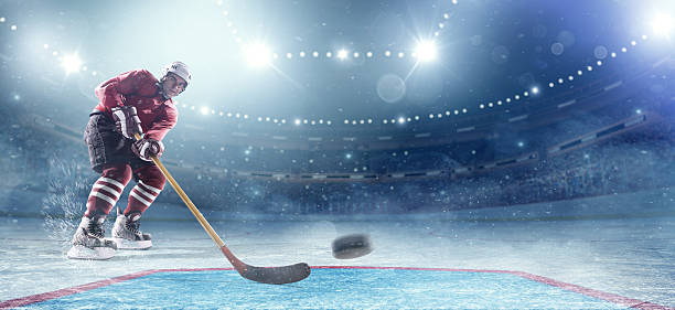 ice hockey-spieler in aktion - ice hockey hockey puck playing shooting at goal stock-fotos und bilder