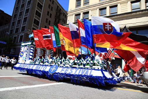 Norfolk, VA. USA - April 26, 2014: The parade of nations parade in Norfolk, Virginia called the Nato Parade, shows a float showing many nations flags.