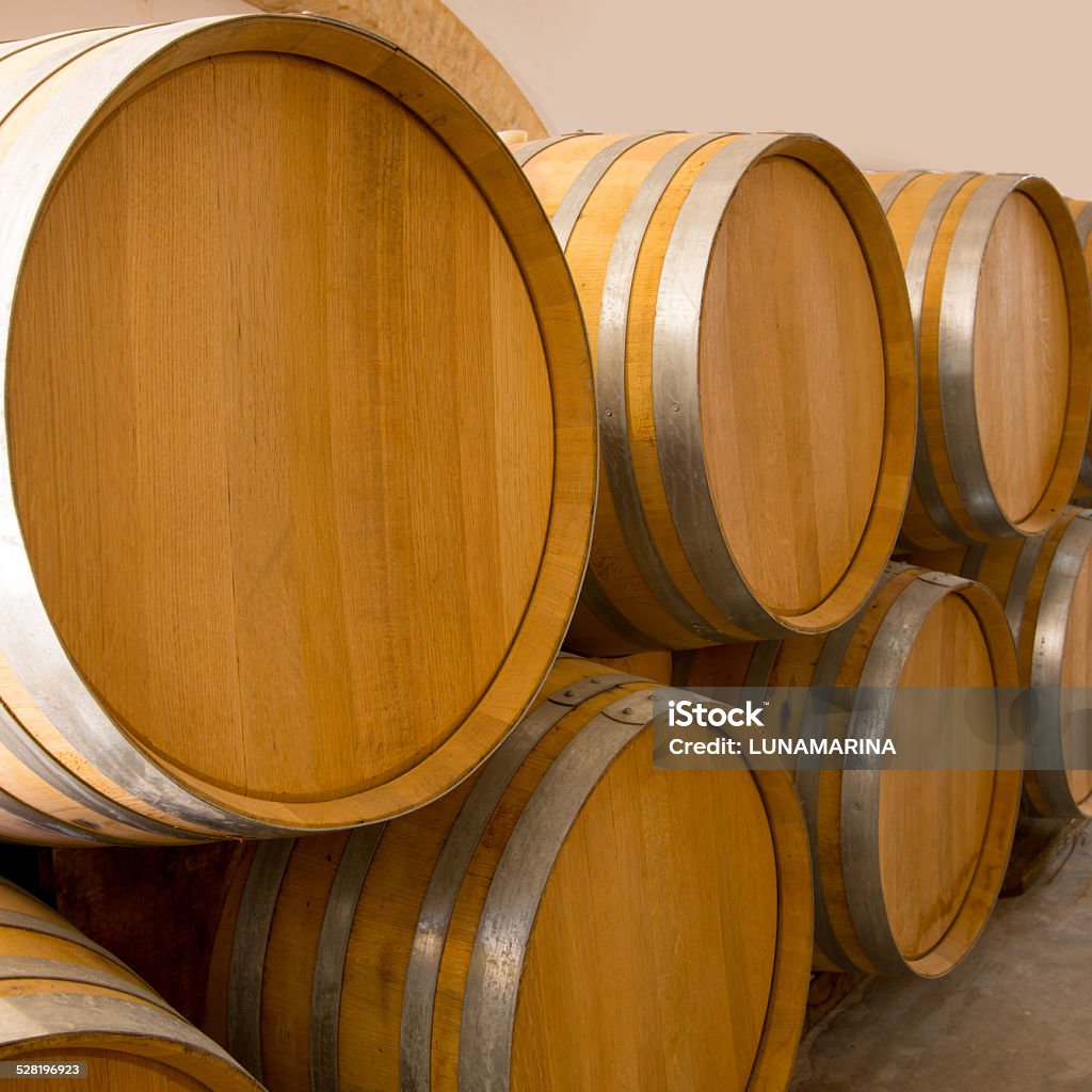 wine wooden oak barrels stacked in a row at winery wine wooden oak barrels stacked in a row at Mediterranean winery Alcohol - Drink Stock Photo