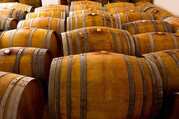 istock wine wooden oak barrels in winery 528197715