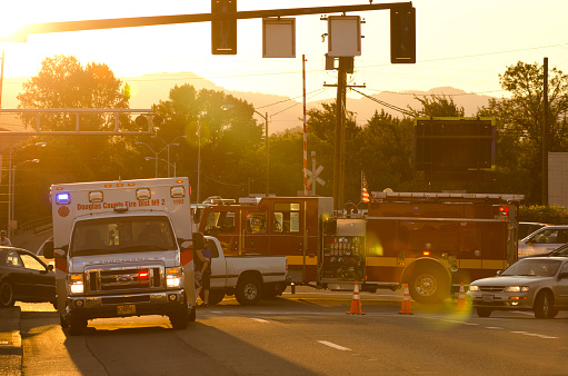 Roseburg, OR, USA - July 12, 2014: Roseburg Oregon Police and Fire deparment at the scene of a single car accident that knocked over a fire hydrant, July 12, 2014