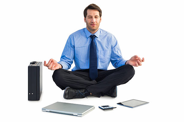 istock Man sitting in lotus pose with laptop, tablet and suitcase 528212365
