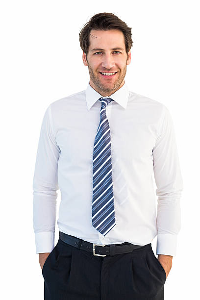 istock Smiling businessman standing with hands in pockets 528212533