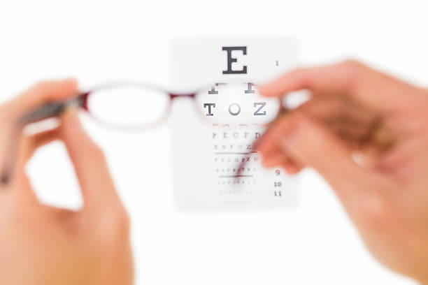 istock Glasses held up to read eye test 528213309