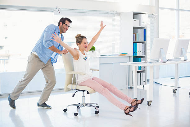 istock Smiling photo editors having fun with on a swivel chair 528213659