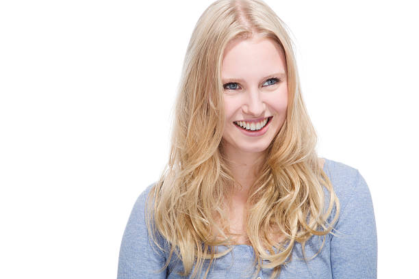 istock Young blonde woman smiling against white background 528214027