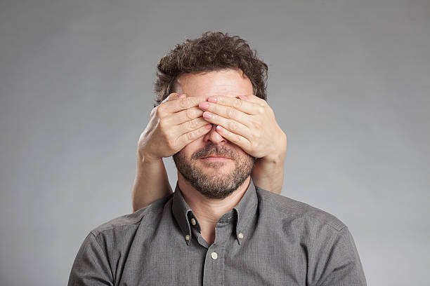 istock Woman's hand covering mature man's eyes 528214245