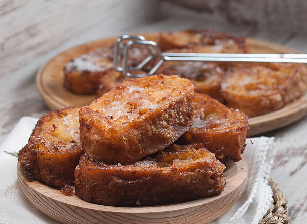 French toasts OLYMPUS DIGITAL CAMERAFrench toasts on a wooden plate. A delicious meal. french toast stock pictures, royalty-free photos & images